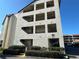 Three-story condo building with balconies and lush landscaping at 106 1St E St # 115, St Petersburg, FL 33715