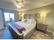 King-size bed, ceiling fan, and private balcony access at 106 1St E St # 115, St Petersburg, FL 33715