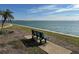 Relaxing waterfront view with a bench and palm tree at 106 1St E St # 115, St Petersburg, FL 33715