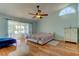 Spacious bedroom with lake view and wood floors at 11507 Whispering Hollow Dr, Tampa, FL 33635