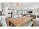Open dining area with a large wooden table and seating at 11654 Stone Pine St, Riverview, FL 33569