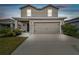 Two-story house with a neutral color scheme and a two-car garage at 11654 Stone Pine St, Riverview, FL 33569