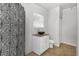 Bathroom with patterned shower curtain, granite vanity, and tile floor at 1619 E Nome St, Tampa, FL 33604