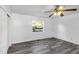 Spacious bedroom with grey vinyl flooring, ceiling fan, and large closet at 1619 E Nome St, Tampa, FL 33604