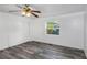 Bright bedroom with grey vinyl flooring, ceiling fan, and large closet at 1619 E Nome St, Tampa, FL 33604