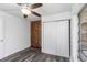 Cozy bedroom with wood-paneled accent wall and mirrored closet doors at 1619 E Nome St, Tampa, FL 33604