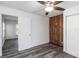 Well-lit bedroom with wood-paneled accent wall and double-door closet at 1619 E Nome St, Tampa, FL 33604