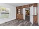 Simple dining room with wood wall accents and grey flooring at 1619 E Nome St, Tampa, FL 33604