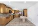 Eat-in kitchen with light wood cabinets and tiled floor at 1619 E Nome St, Tampa, FL 33604