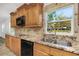 Modern kitchen with granite countertops and wood cabinets at 1619 E Nome St, Tampa, FL 33604