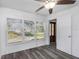 Living room with grey flooring and large windows, showing access to front door at 1619 E Nome St, Tampa, FL 33604