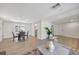 Light-filled living room features a comfortable sitting area and wood-look flooring at 1660 83Rd N Ave, St Petersburg, FL 33702