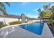 Relaxing rectangular pool with solar panels on the house at 1660 83Rd N Ave, St Petersburg, FL 33702