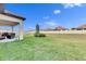 Spacious backyard with grassy lawn, patio furniture, and a grill at 17219 Scuba Crest St, Wimauma, FL 33598