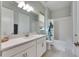 Clean bathroom with white cabinets, subway tile, and a bathtub at 17219 Scuba Crest St, Wimauma, FL 33598