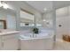 Bathroom with corner soaking tub and walk-in shower at 17219 Scuba Crest St, Wimauma, FL 33598