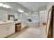 Spa-like bathroom with soaking tub and double vanity at 17219 Scuba Crest St, Wimauma, FL 33598