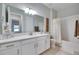 Bathroom with white cabinets, quartz countertop, and a bathtub at 17219 Scuba Crest St, Wimauma, FL 33598