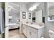 Bathroom with white cabinets, quartz countertop and a view of a bedroom at 17219 Scuba Crest St, Wimauma, FL 33598