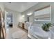 Bathroom with double vanity, soaking tub and a view into bedroom at 17219 Scuba Crest St, Wimauma, FL 33598