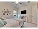 Bedroom with a queen bed, TV, and coastal decor at 17219 Scuba Crest St, Wimauma, FL 33598