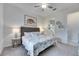 Spacious bedroom with king bed, ensuite bathroom access, and coastal decor at 17219 Scuba Crest St, Wimauma, FL 33598
