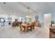 Open concept dining room with wood table and chairs, adjacent to kitchen at 17219 Scuba Crest St, Wimauma, FL 33598