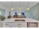 Island kitchen with white cabinets, quartz countertops, and stainless steel appliances at 17219 Scuba Crest St, Wimauma, FL 33598