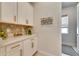 White kitchen cabinets with gold hardware and a quartz countertop at 17219 Scuba Crest St, Wimauma, FL 33598