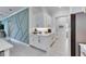 Modern kitchen with white cabinets, quartz countertops, and gold hardware at 17219 Scuba Crest St, Wimauma, FL 33598