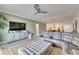 Living room with sectional sofa, large TV, and access to kitchen at 17219 Scuba Crest St, Wimauma, FL 33598
