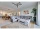 Spacious living room with sectional sofa, large TV, and ceiling fan at 17219 Scuba Crest St, Wimauma, FL 33598