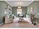 Home office with green walls, wood desk, and comfortable seating at 17219 Scuba Crest St, Wimauma, FL 33598