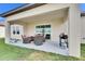 Covered patio with seating area and grill at 17219 Scuba Crest St, Wimauma, FL 33598