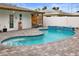 Freeform swimming pool with a waterfall feature and patio at 1725 Santa Barbara Dr, Dunedin, FL 34698