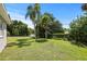 Large backyard with lush green grass and mature trees at 1742 Bayshore Blvd, Dunedin, FL 34698