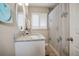 Bathroom with granite vanity, round mirror, and shower/tub combo at 1742 Bayshore Blvd, Dunedin, FL 34698