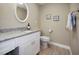 Small bathroom with granite countertop and white cabinets at 1742 Bayshore Blvd, Dunedin, FL 34698