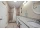 Bathroom with double vanity, granite countertops, and shower at 1742 Bayshore Blvd, Dunedin, FL 34698