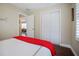 Bright bedroom with double doors leading to closet and view into another room at 1742 Bayshore Blvd, Dunedin, FL 34698