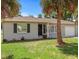 Ranch-style home with gray exterior and palm trees at 1742 Bayshore Blvd, Dunedin, FL 34698