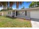 Charming house with gray exterior and landscaping at 1742 Bayshore Blvd, Dunedin, FL 34698