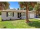 Single-story home with gray exterior and landscaping at 1742 Bayshore Blvd, Dunedin, FL 34698