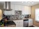Modern kitchen with white cabinets and granite countertops at 1742 Bayshore Blvd, Dunedin, FL 34698