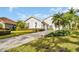 Two-story house with palm trees and a paved driveway at 2607 Grand Lakeside Dr, Palm Harbor, FL 34684