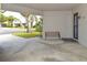 Covered carport with a bench, offering shade and parking at 2637 Barksdale Ct # 2637, Clearwater, FL 33761