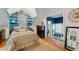 Charming bedroom with blue walls, built-in shelving and hardwood floors at 2886 Bay Shore Dr, Safety Harbor, FL 34695