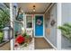 Inviting front door entrance with blue door and unique decor at 2886 Bay Shore Dr, Safety Harbor, FL 34695