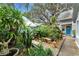 Landscaped front yard with walkway and lush tropical plants at 2886 Bay Shore Dr, Safety Harbor, FL 34695