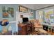 Charming home office features a wooden desk, comfortable chair, and a globe at 2886 Bay Shore Dr, Safety Harbor, FL 34695